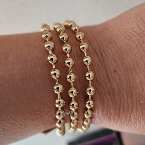 002. Bangle dorado esferas
